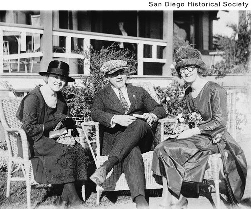 Hal Roach, his wife Marguerite Nichols, and Mrs. H. Walker seated in wicker chairs