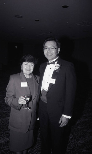 Stewart Kwoh posing with an unidentified woman at a Pacific American Legal Center event, Los Angeles, ca. 1989