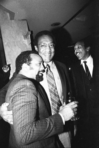 Bill Cosby talking with Quincy Jones at a Neighbors of Watts benefit, Los Angeles, 1982