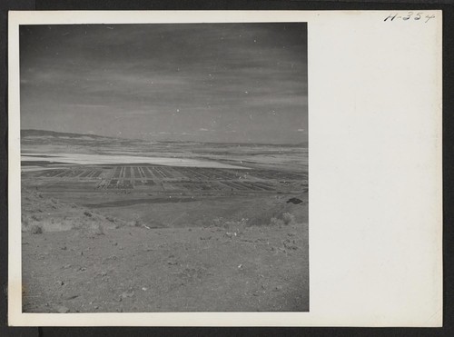 A distant view of the Tule Lake Relocation Center and a portion of its vast agricultural project. Photographer: Mace, Charles E. Newell, California