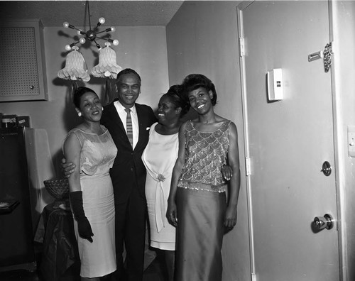 Eula and La Doris McClaney posing with Charles Williams at a wedding shower, Los Angeles, 1960
