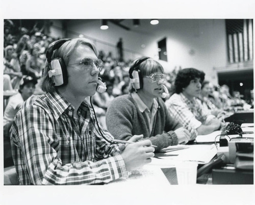 Student journalists at basketball game, mid 1970s