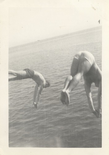Two unidentified men diving off wharf