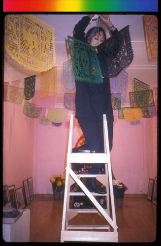 Margaret Sosa Hanging Papel Picado for the Day of the Dead