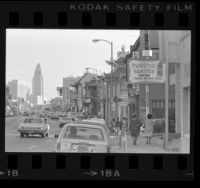 Street scene in Chinatown with Los Angeles City Hall in background, 1978