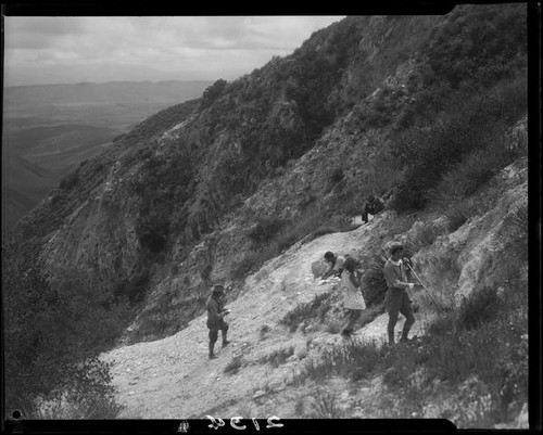 Men, Clarice Barclay, and girl on rocky hillside, near Magic Mountain, Ventura County, 1930