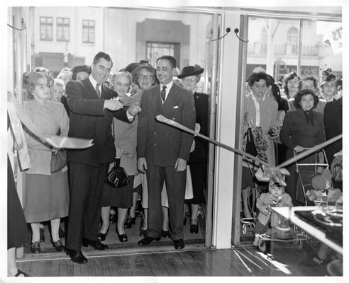 [San Francisco Supervisor Martin Lewis cutting the ribbon at a grand opening ceremony for the Weinstein Company department store at 120 West Portal Avenue]