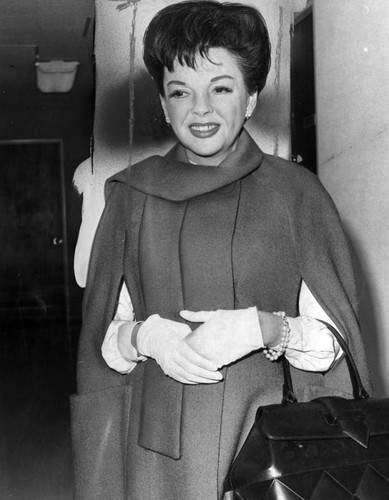 Judy Garland arrives with a smile
