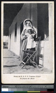 Missionary sister holding up a baby, Congo, ca.1900-1930