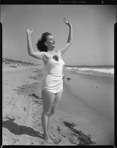 Betty Herrick [?] on beach, [1935-1955]