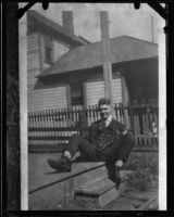 Actor Clark Gable as a young man, on porch with ukulele, [Ohio], [1920s?]