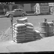 Bags of cement stacked on a street