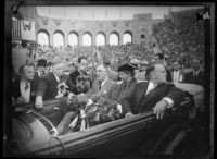 President Franklin D. Roosevelt speaks to reporters from car with First Lady Eleanor Roosevelt and Mayor Frank Shaw at the Los Angeles Memorial Coliseum, October 1, 1935