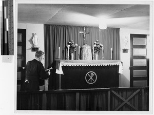 Priest praying in the Catholic Chapel at Granada Japanese Relocation Camp, Amache, Colorado, ca. 1942