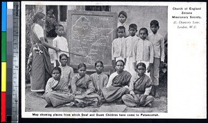 Students gather around a map with their teacher, Pālayankottai, India, ca.1900-1920
