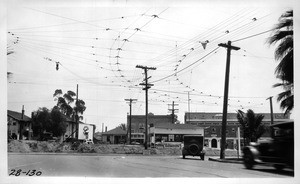 On 10th Street showing clearance between curb at southwest corner and where street car would make turn at Hoover Street, Los Angeles, 1928