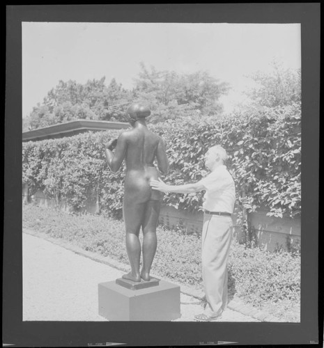 [Candid photographs of House Beautiful staff]. Maynard Parker in garden, Pulitzer residence