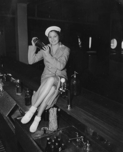 Female bartender posing
