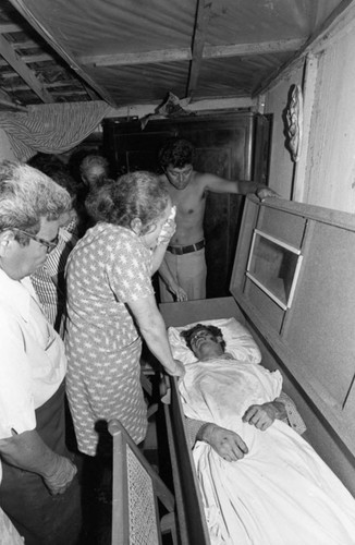 Woman grieving near a coffin, Nicaragua, 1979