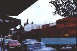 Southern Pacific train traveling down North Main Street Sebastopol near the IOOF building and Carlson's department store in downtown Sebastopol, California, 1977