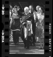 Charlie Chaplin, with wife Oona waving to crowd upon arrival in Los Angeles, Calif., 1972