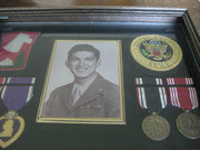 Enlarged Image of the Top-Right Section of the Framed Case With Acevedo's Military Honors, Awards, and Other Mementos