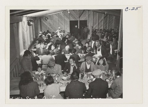 Lunch time, cafeteria style, at the Santa Anita Assembly Center where many thousands of evacuees of Japanese ancestry are temporarily housed pending transfer to War Relocation Authority Centers where they will spend the duration. Photographer: Albers, Clem Arcadia, California