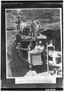 Mouth of Black Jack Mine on Black Jack Mountain on Santa Catalina Island, showing eight miners, October 16, 1935