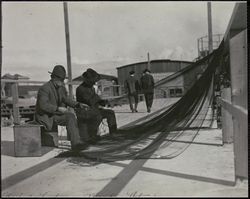 Mending fishing nets at Fisherman's Wharf, 41 The Embarcadero, San Francisco, California, 1920s
