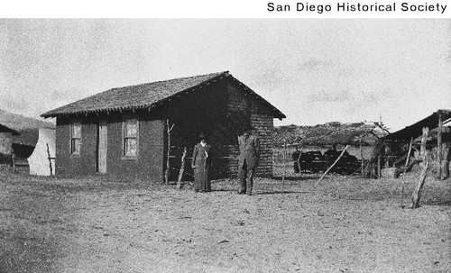 Man and a woman standing outside ranch house in Baja California