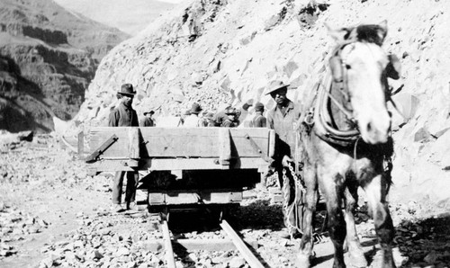 Horse-drawn rail cart and construction workers during railroad construction on the Feather River