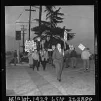 Pickets from Local Union 399 walking picketline at gate of Santa Anita Park, Calif., 1964