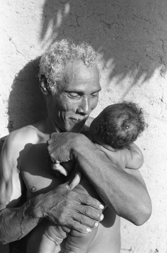 Man holding a baby, San Basilio de Palenque, 1976