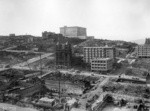 [View looking northwest toward Nob Hill from above circa Stockton and Geary Sts. during reconstruction. Union Square, lower left; Temple Emanu-el, right center; Fairmont Hotel atop hill]