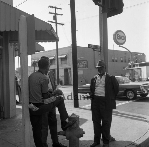 Three men gather at 43rd Street, Los Angeles, 1971