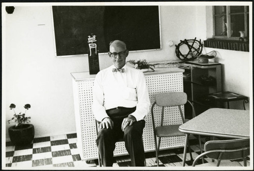 Charles Protzman seated on a chair, 1961-05