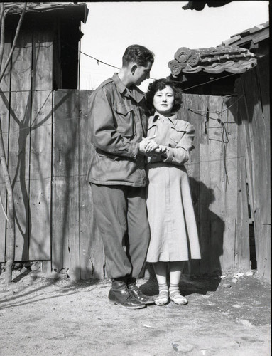 Soldier posing with a woman at a Korean brothel