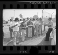 Rapid Transit District Division Manager Jack Greasby handing out letters to picketing drivers in El Monte, Calif., 1976