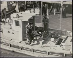 Fishermen repairing a fishing boat, 41 The Embarcadero, San Francisco, California, 1920s