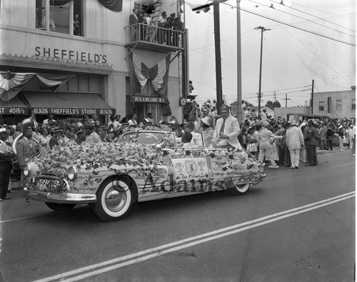 Men and women along parade route, Los Angeles, 1956