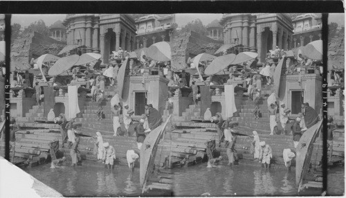 One of the innumerable Ghats which line the banks of the Ganges, covered with pilgrims come to bathe in the sacred waters, India, Benares (?)