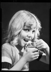 Girl eating ice cream from 5¢ cup, Mary Alice, Southern California, 1932