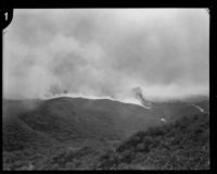 Smoke billows from behind a ridge during a brush fire in Griffith Park, Los Angeles, 1929