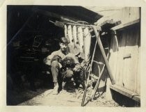 Young man with cocker spaniels and fish, c. 1920