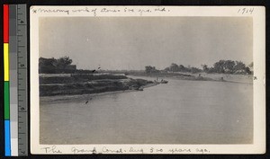 Large canal flowing between old masoned banks, China, ca.1914