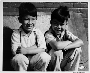 Two young boys smiling in Chinatown