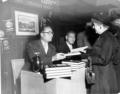 [Lucius Beebe at book signing]