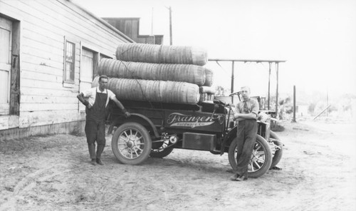 J.E. Bird, Jr. and Henry William Hillebrecht standing beside the Franzen Hardware Company truck, 1912