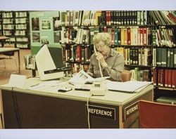 Sebastopol librarian, Janis Valtenbergs, at her library reference desk, Sebastopol, California, 1970s