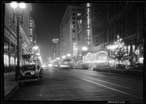 Northward view of Broadway from Ninth Street with Christmas decorations and neon signs for stores, 1930-1931